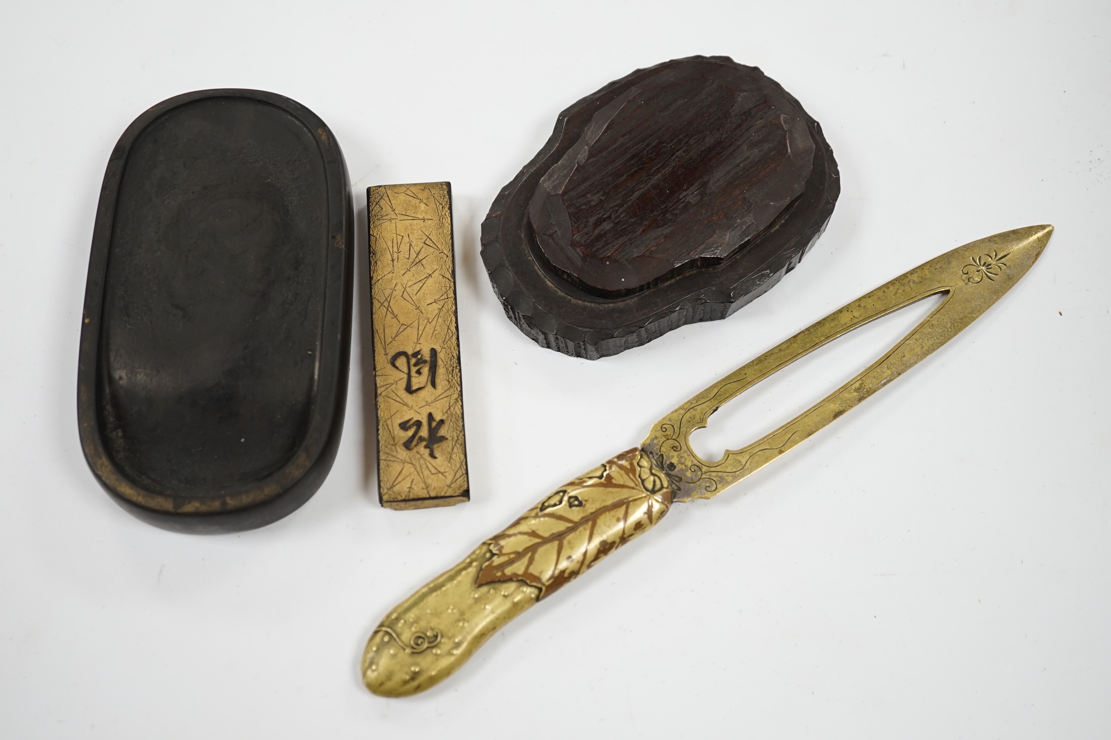 Literati interest: a Chinese red lacquer writing box, 26.5 x 24 x 6.5cm, with two inkstones, a brass paper cutter and ink cake. Condition - fair, some damage to edges and corners of the box